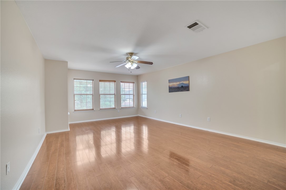 11228 Pickard Lane Austin, TX 78748 - Photo 23 of 32 a view of an empty room with wooden floor and a window