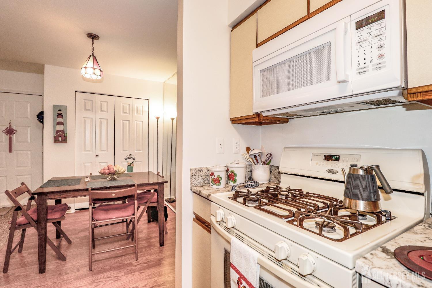 62 Haverhill Place Somerset, NJ 08873 - Photo 14 of 26 a kitchen with a stove and a table
