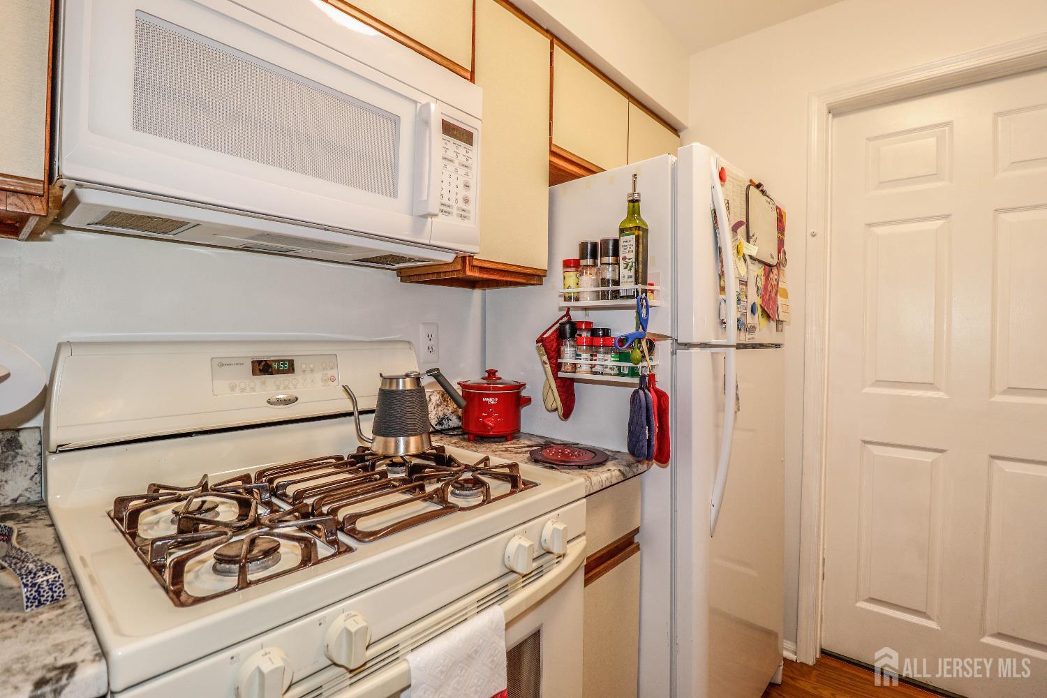 62 Haverhill Place Somerset, NJ 08873 - Photo 16 of 26 a kitchen with stove and white cabinets