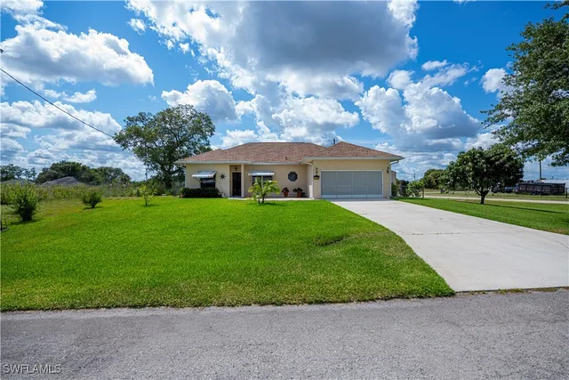 a front view of house with yard and green space