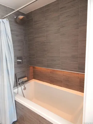 a bathroom with a bathtub and shower