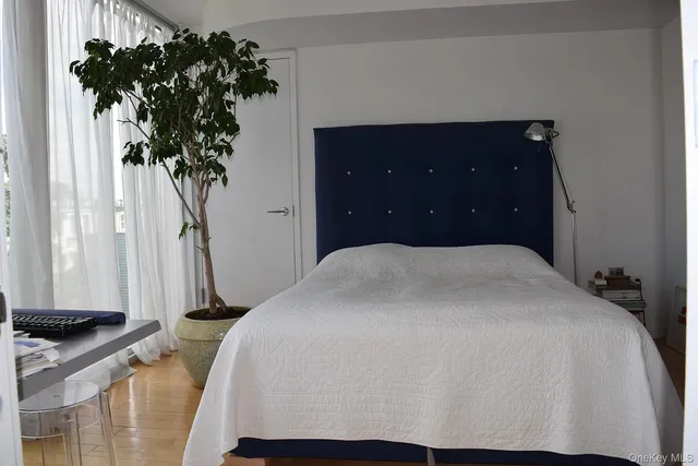 a bed sitting in a bedroom and mirror