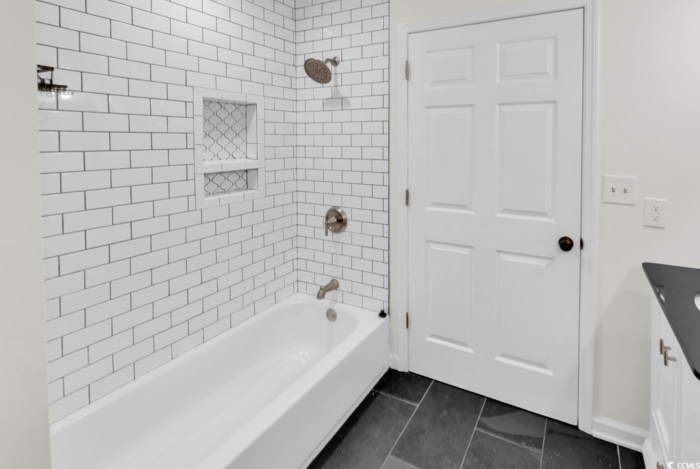 506 Merrywood Drive Conway, SC 29526 - Photo 23 of 40 Bathroom with vanity, washtub / shower combination, and dark tile patterned floors