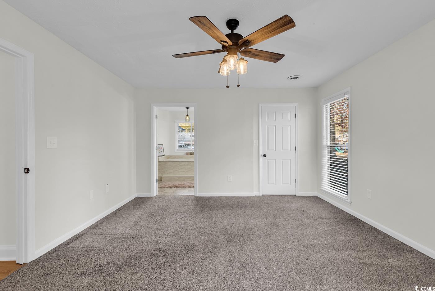 506 Merrywood Drive Conway, SC 29526 - Photo 25 of 40 Unfurnished bedroom with multiple windows, ceiling fan, carpet flooring, and ensuite bathroom
