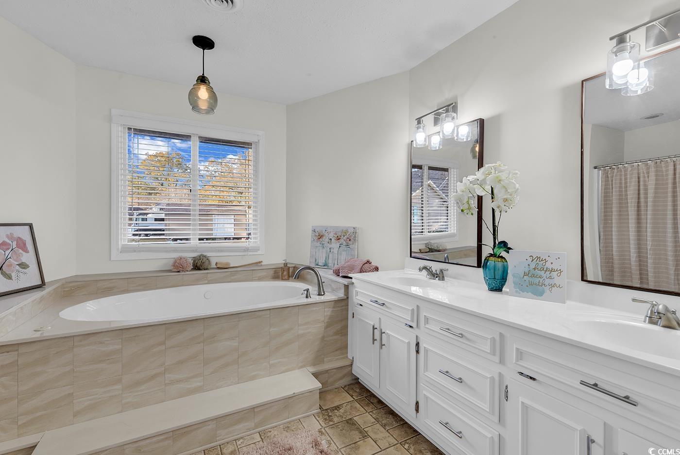 506 Merrywood Drive Conway, SC 29526 - Photo 30 of 40 Full bath with double vanity, a shower with curtain, a garden tub, and stone tile floors