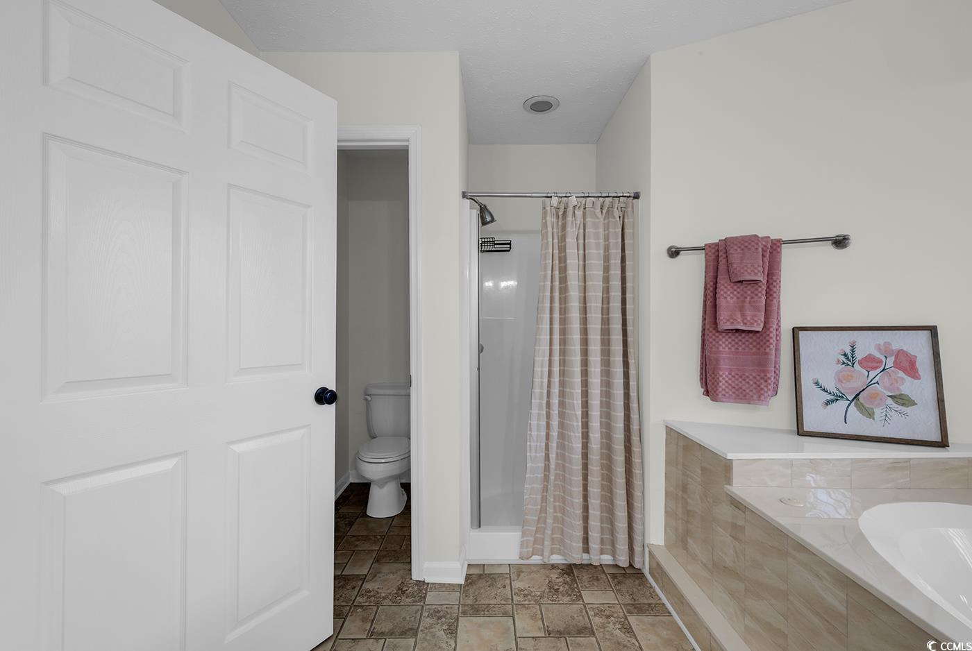 506 Merrywood Drive Conway, SC 29526 - Photo 31 of 40 Full bathroom with a garden tub, a stall shower, and stone finish floors