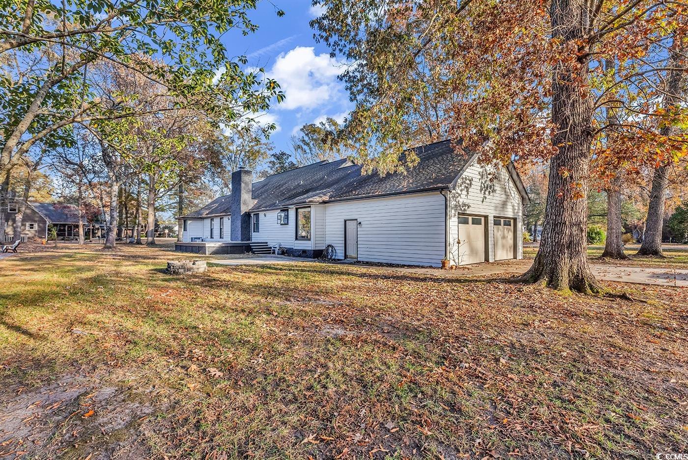 506 Merrywood Drive Conway, SC 29526 - Photo 35 of 40 Back of property with a patio area, a garage, a yard, and a chimney