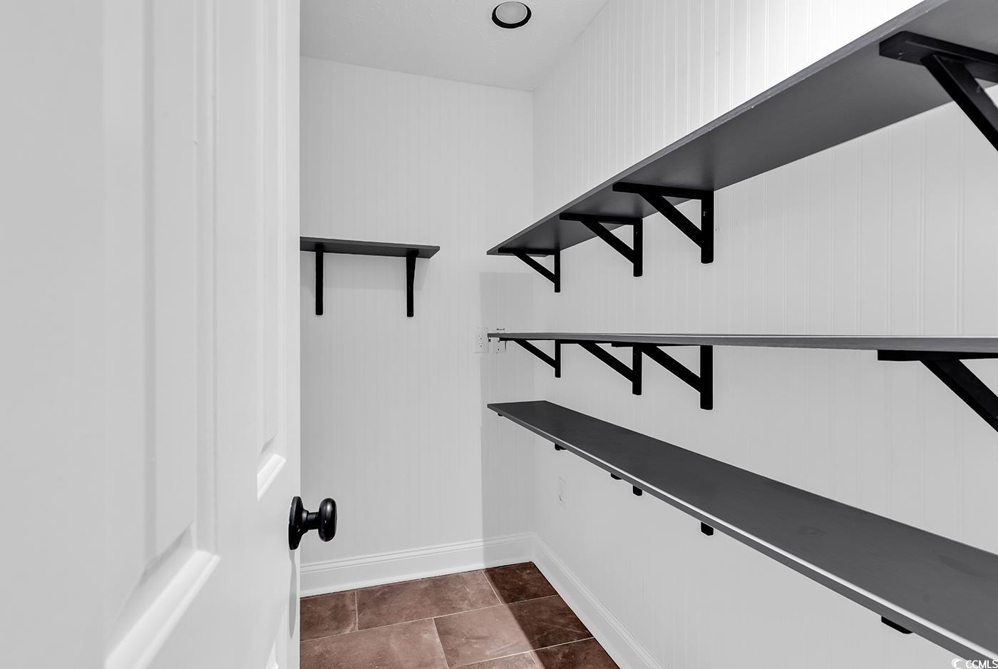 506 Merrywood Drive Conway, SC 29526 - Photo 9 of 40 Walk in closet featuring dark tile patterned floors