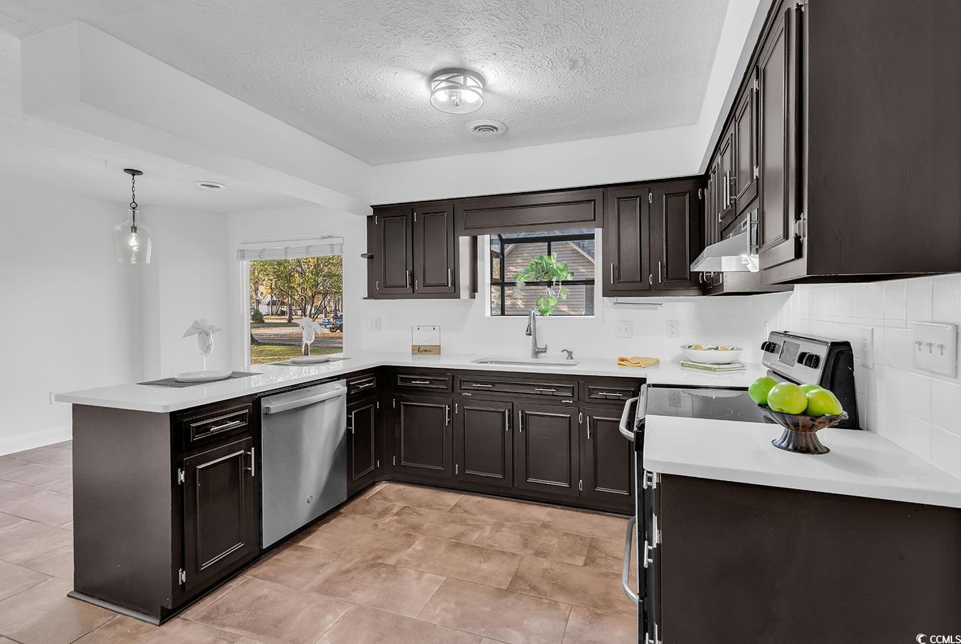 506 Merrywood Drive Conway, SC 29526 - Photo 10 of 40 Kitchen with appliances with stainless steel finishes, a peninsula, a textured ceiling, hanging light fixtures, and plenty of natural light