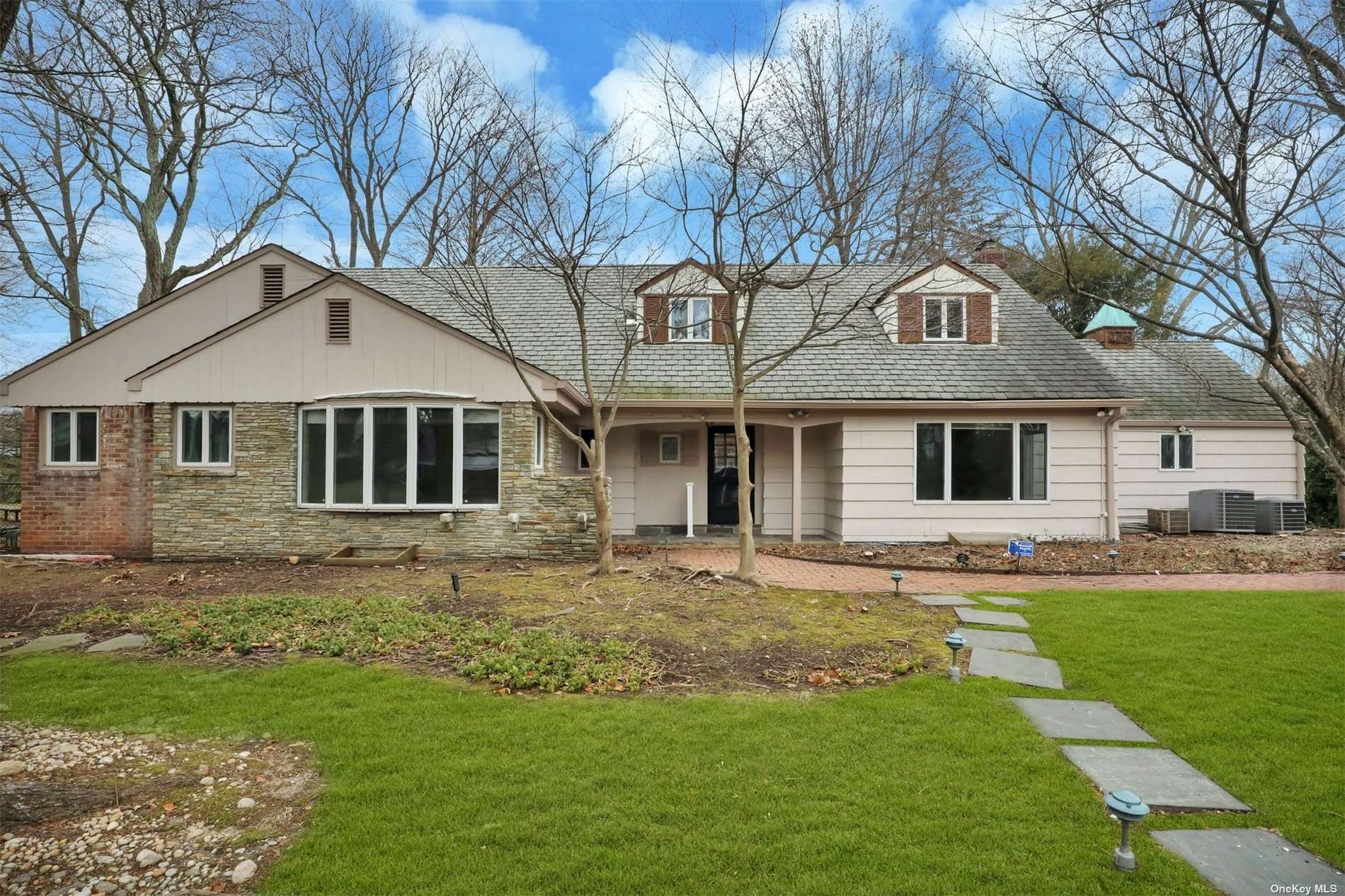 a front view of a house with a garden