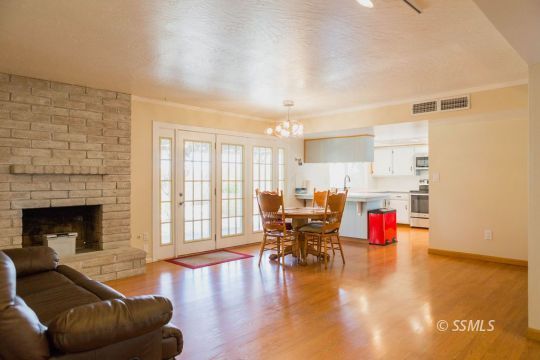 712 Peg Street Ridgecrest, CA 93555 - Photo 11 of 44 a living room with furniture and fireplace with wooden floor