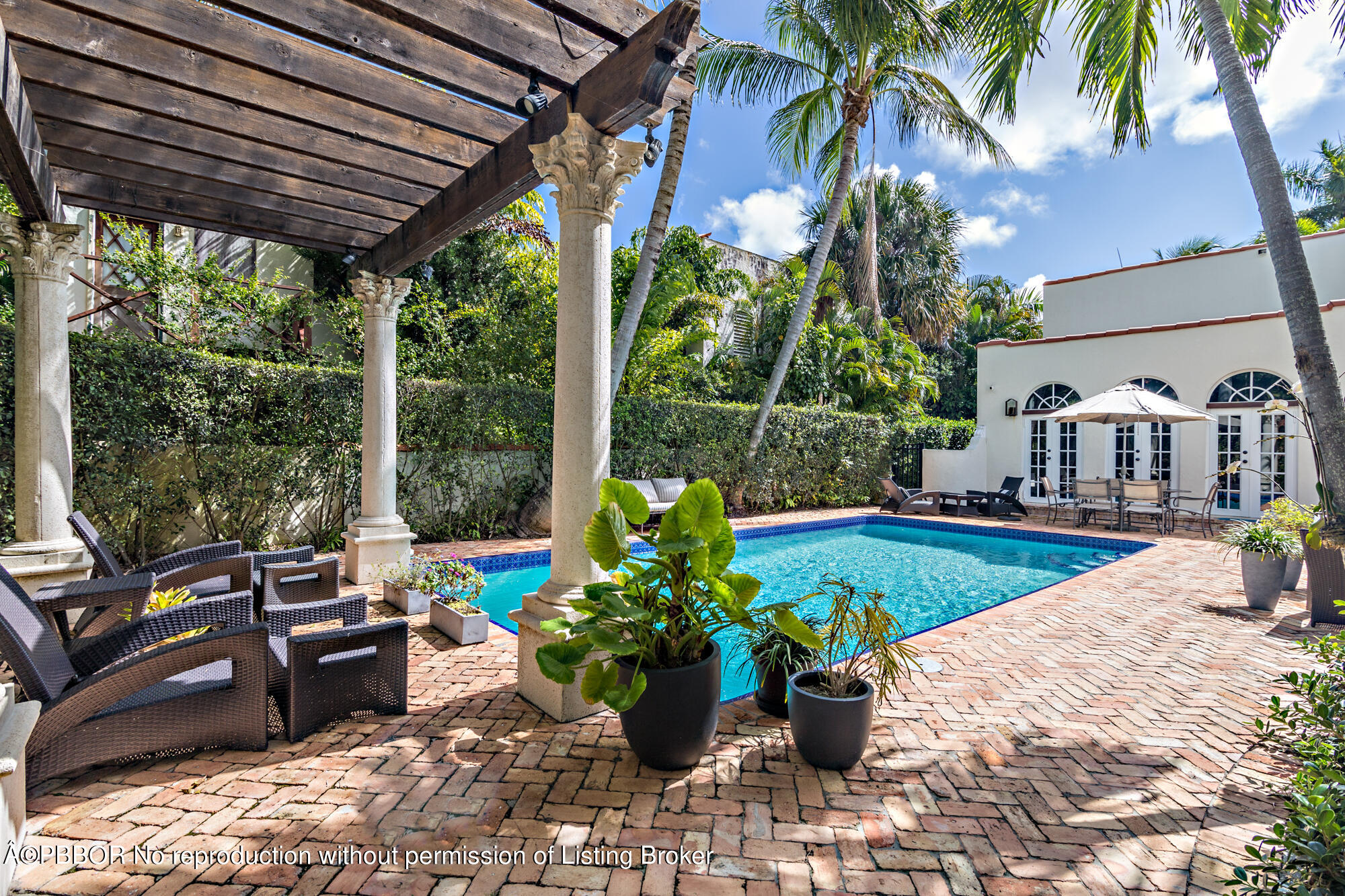 231 Sunset Road West Palm Beach, FL 33401 - Photo 19 of 22 a view of a porch with furniture and a potted plant