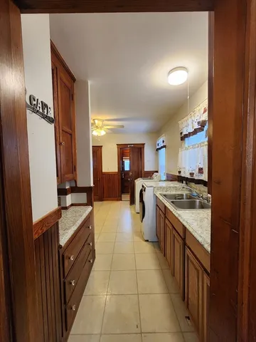 a kitchen with a sink appliances and cabinets