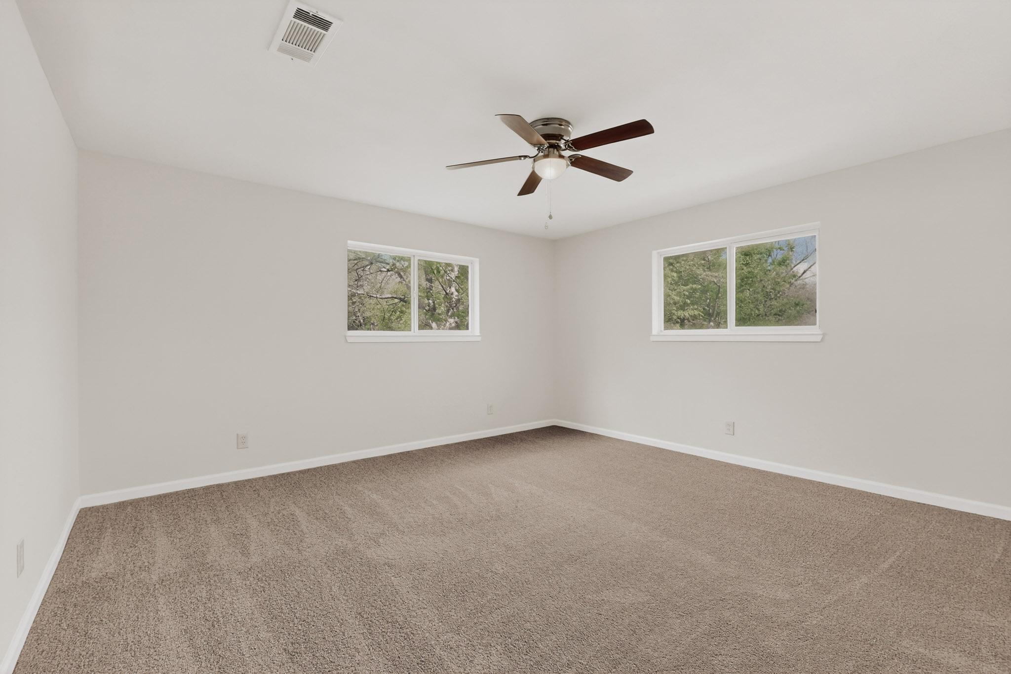 812 George Street Taylor, TX 76574 - Photo 16 of 34 Spare room featuring plenty of natural light, carpet flooring, and a ceiling fan