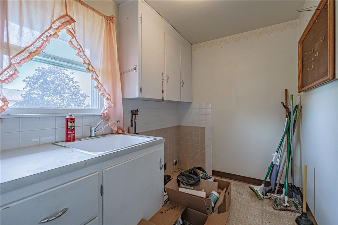 4815 Mill Road Schnecksville, PA 18078 - Photo 23 of 48 A well-lit utility room features ample cabinet storage and a practical sink.