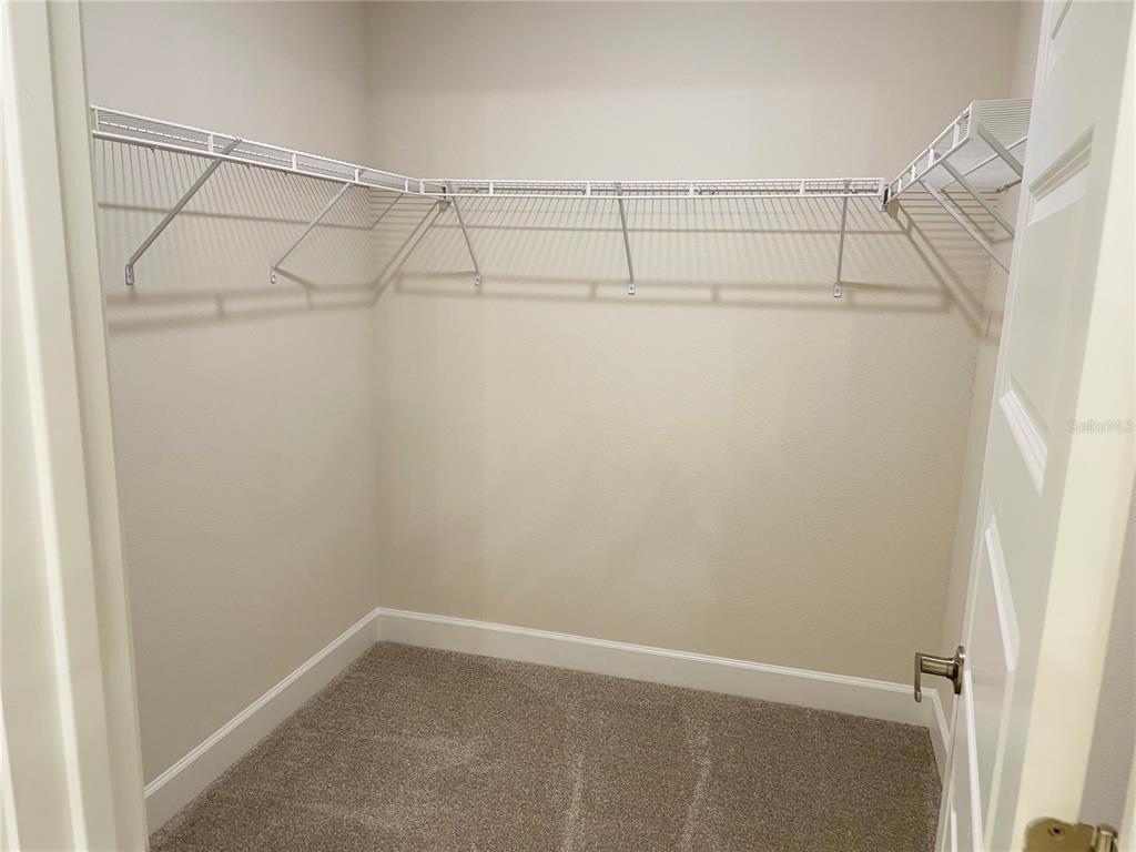 7625 Bent Tree Loop St. Cloud, FL 34773 - Photo 5 of 8 a view of a room with racks on the wall