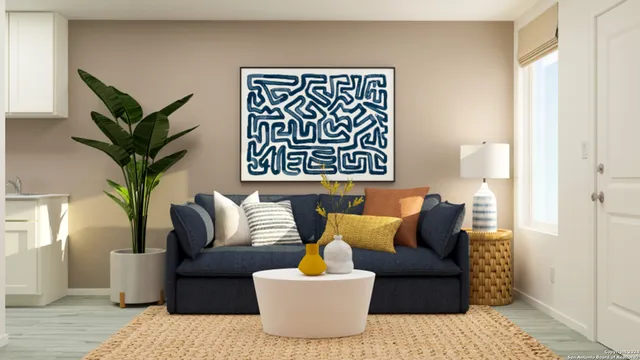 a living room with furniture and a potted plant