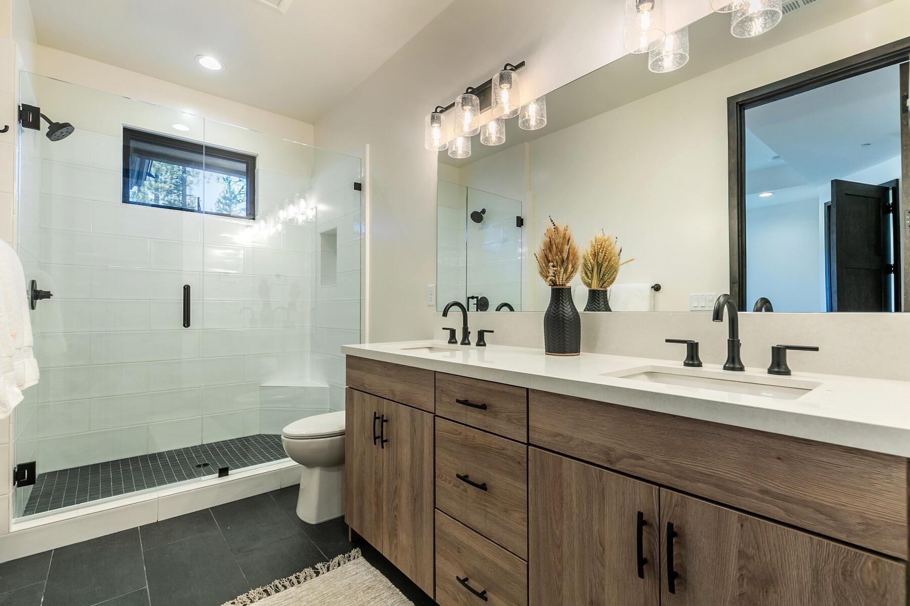 10244 Modane Place Truckee, CA 96161 - Photo 17 of 21 a spacious bathroom with double sink a toilet a shower and a mirror