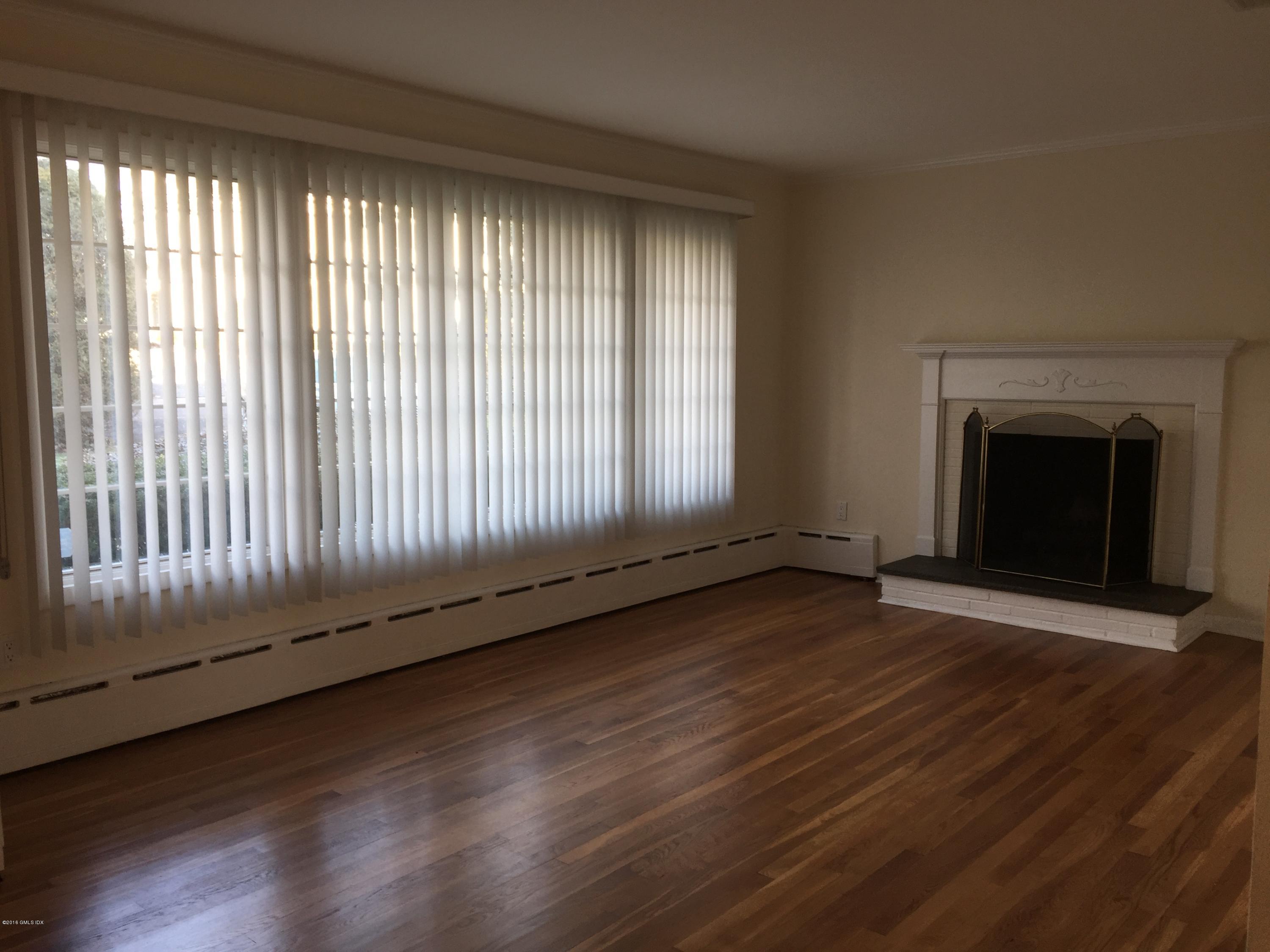 10 Miltiades Avenue Riverside, CT 06878 - Photo 2 of 16 an empty room with wooden floor and fireplace
