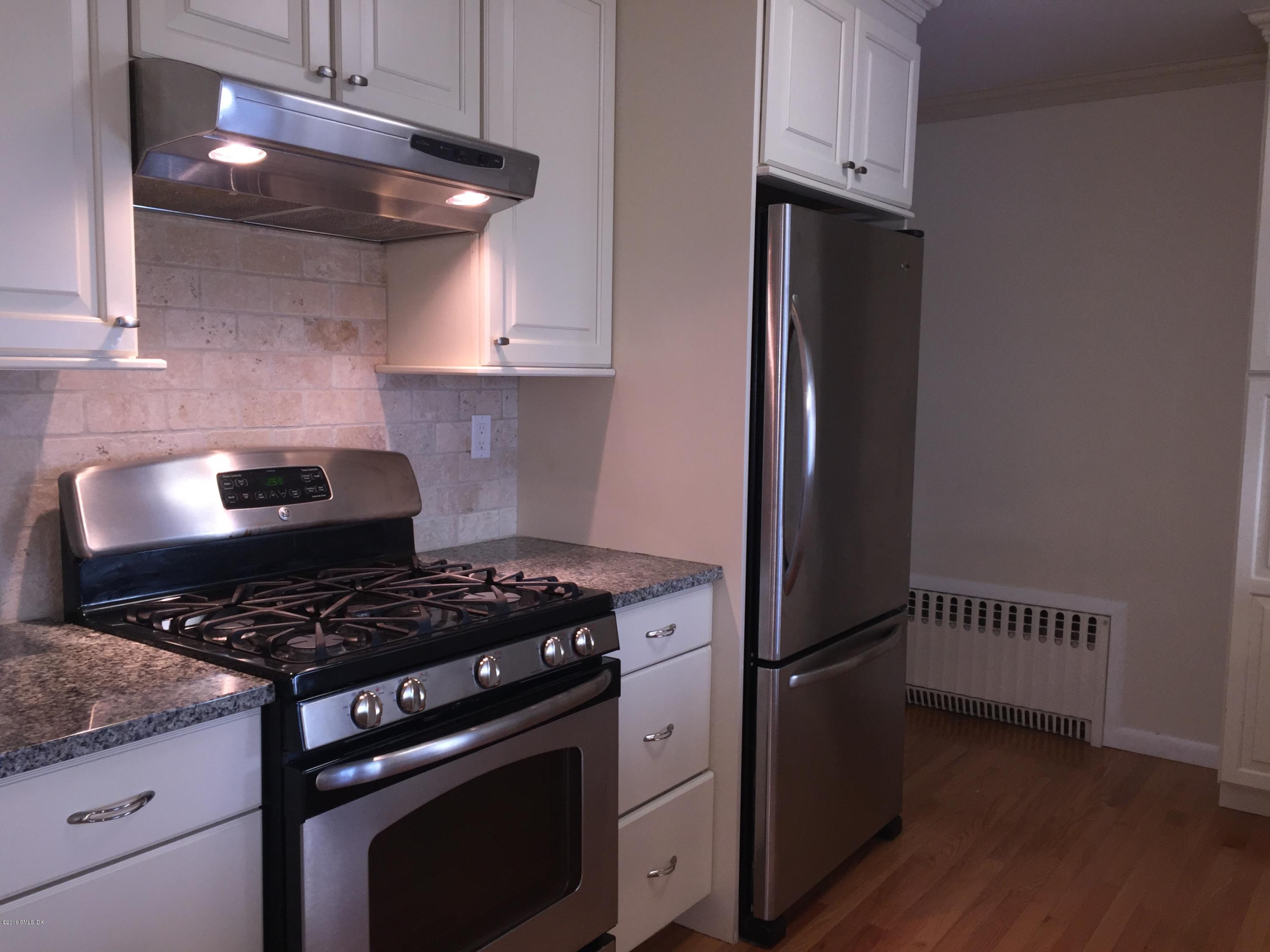 10 Miltiades Avenue Riverside, CT 06878 - Photo 3 of 16 a kitchen with stainless steel appliances granite countertop a stove and a refrigerator