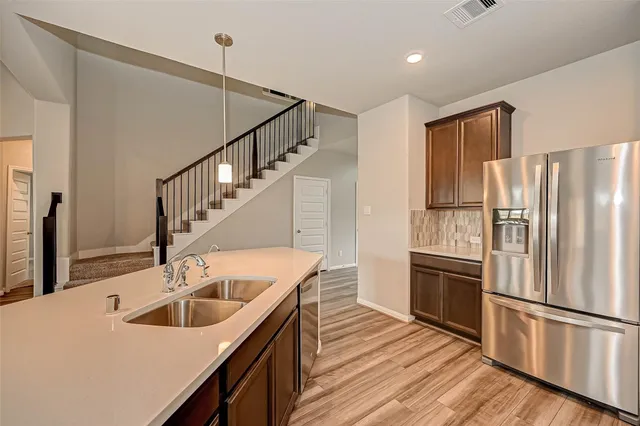 a kitchen with kitchen island a sink appliances and cabinets
