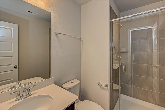 a bathroom with a sink toilet and shower