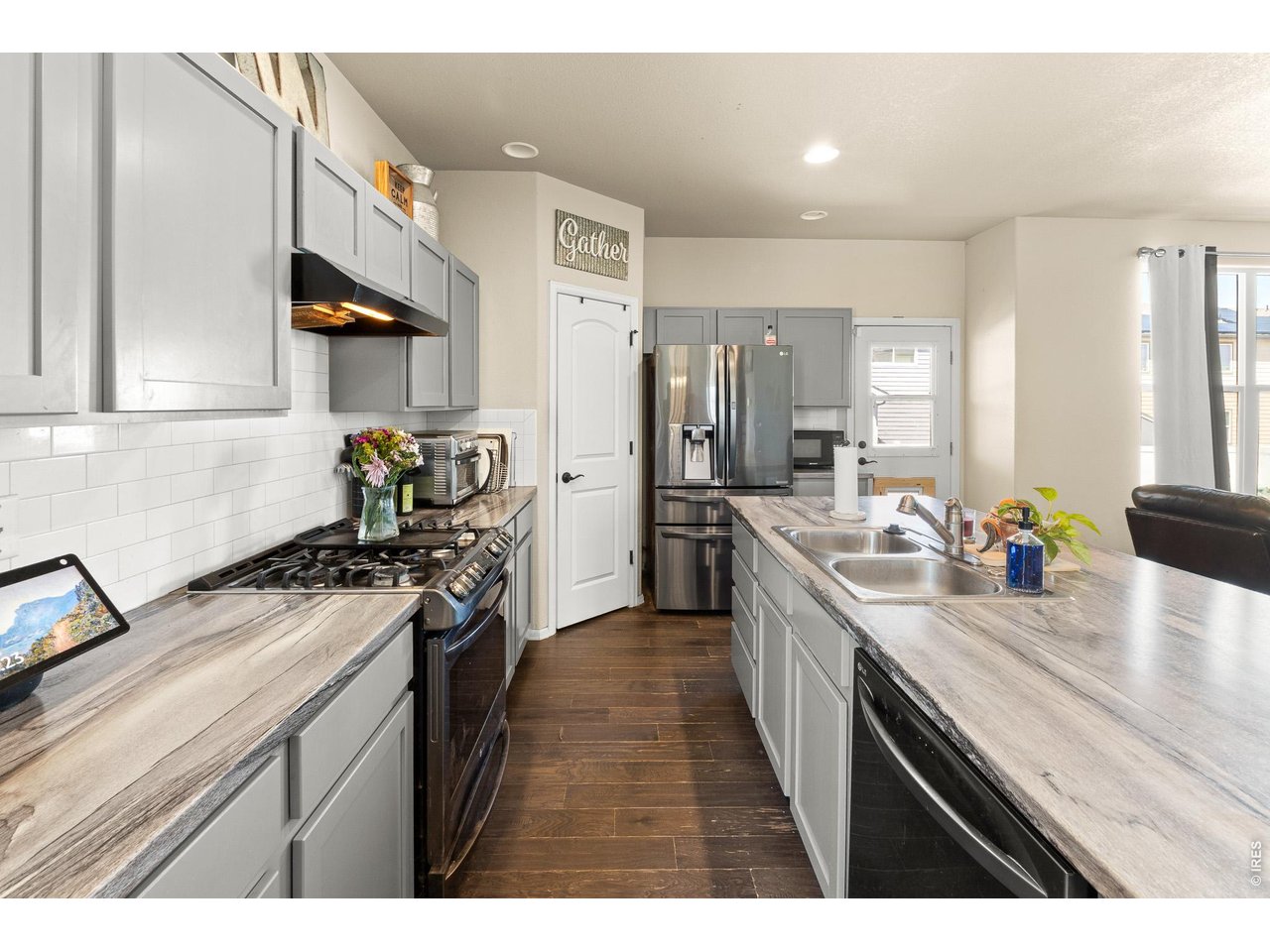 8847 16th St Road Greeley, CO 80634 - Photo 18 of 38 a kitchen with a sink stove and refrigerator