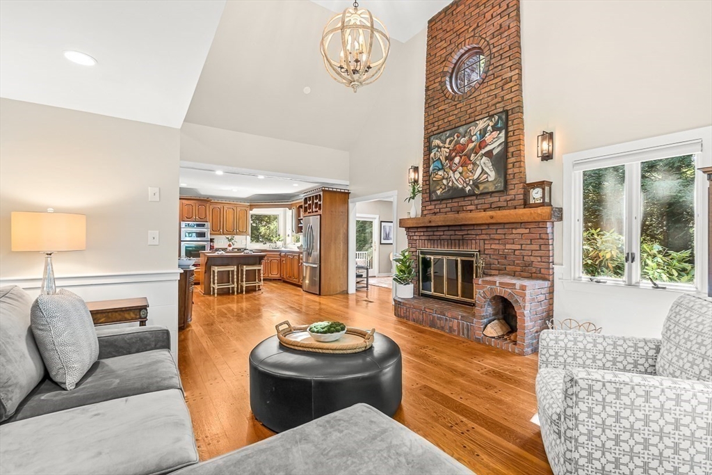 19 Louis Drive Wellesley, MA 02481 - Photo 12 of 30 a living room with furniture a fireplace and a table