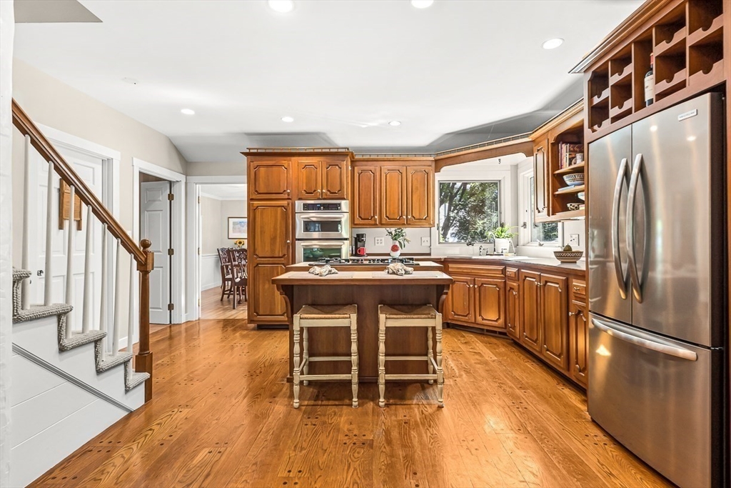 19 Louis Drive Wellesley, MA 02481 - Photo 13 of 30 a kitchen with stainless steel appliances a stove a sink a refrigerator and island with wooden floor
