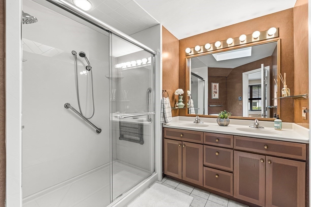 19 Louis Drive Wellesley, MA 02481 - Photo 20 of 30 a spacious bathroom with a shower sink and mirror