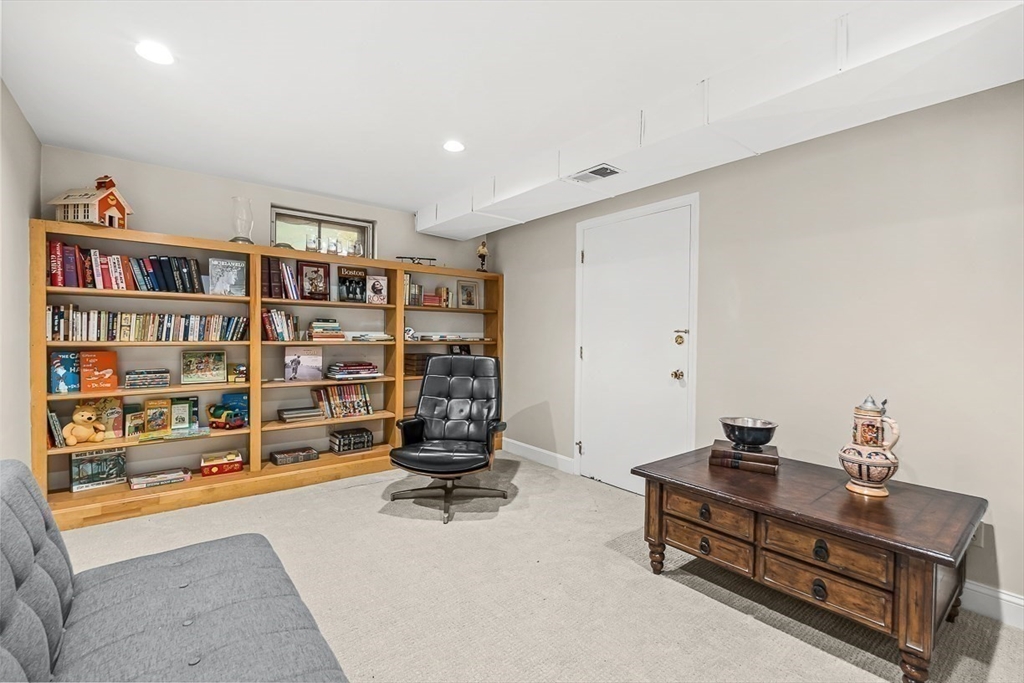 19 Louis Drive Wellesley, MA 02481 - Photo 26 of 30 a living room with furniture cabinets and a book shelf