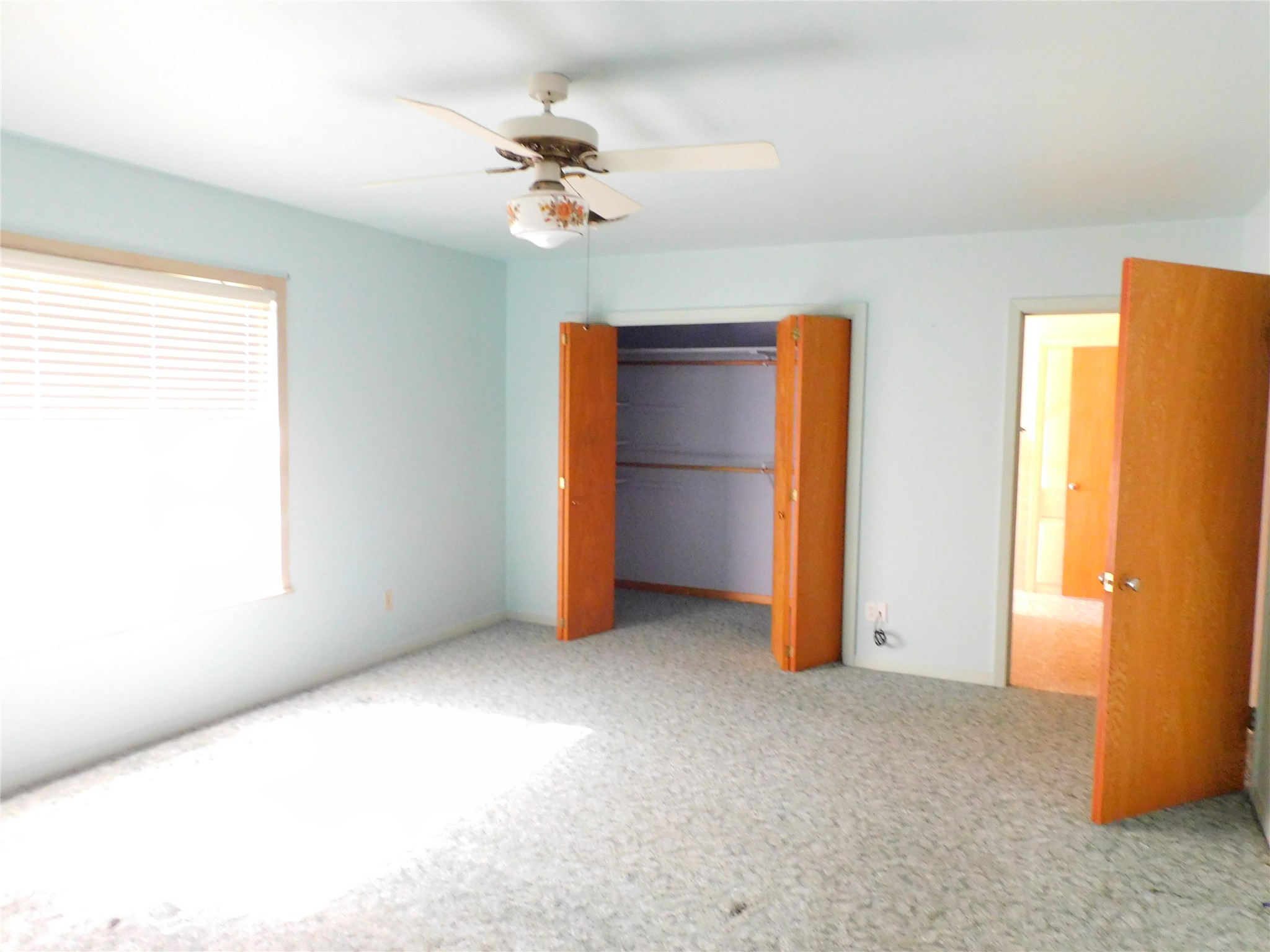 2408 Gun And Rod Road Brenham, TX 77833 - Photo 9 of 17 a view of an empty room with closet and a chandelier fan