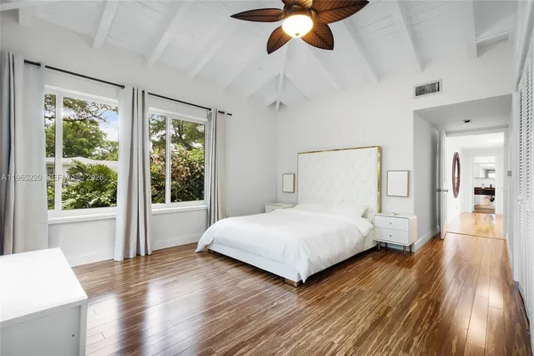 a bedroom with a large bed and a chandelier