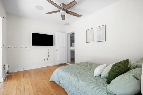 a bedroom with a bed and a flat screen tv
