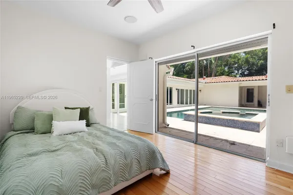 a bedroom with a large bed and a large window
