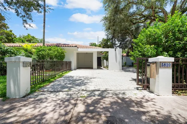 a view of a backyard with wooden fence