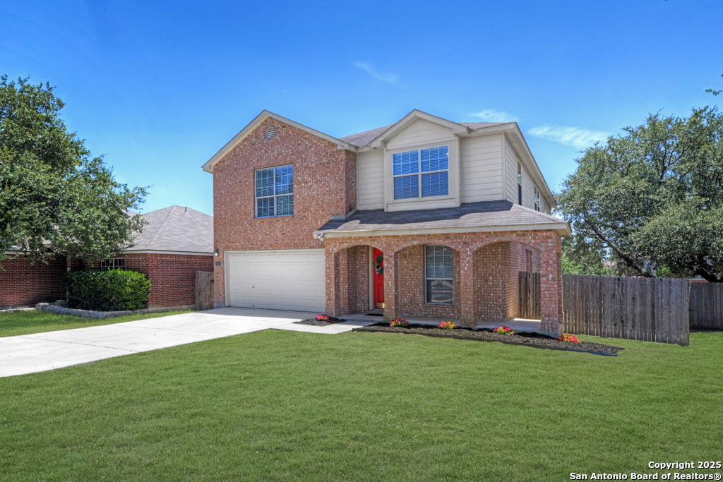 a front view of a house with a yard and garage