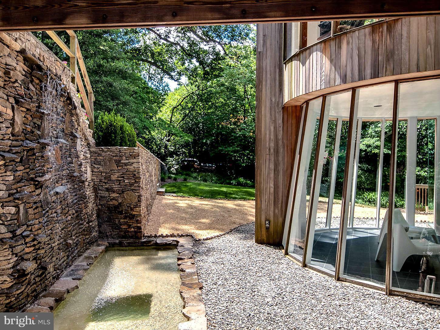 2724 Chain Bridge Road Northwest Washington, DC 20016 - Photo 27 of 30 a view of backyard with large tree and wooden fence