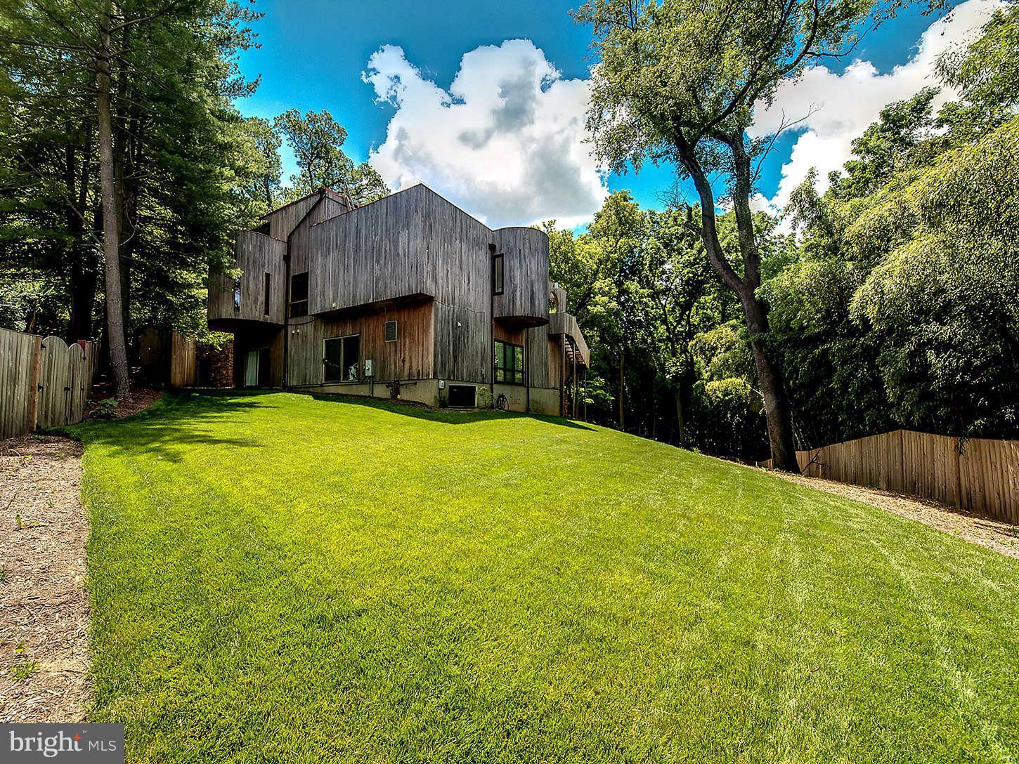 2724 Chain Bridge Road Northwest Washington, DC 20016 - Photo 30 of 30 a view of a house with a yard and large trees