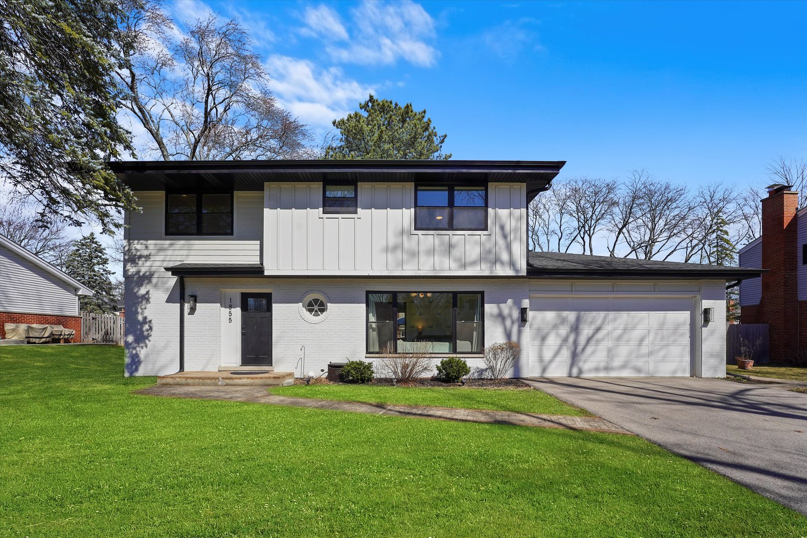 Undisclosed Address Northbrook, IL 60062 - Photo 1 of 46 a front view of a house with a garden