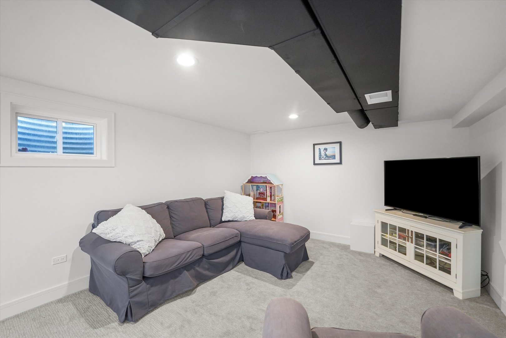 Undisclosed Address Northbrook, IL 60062 - Photo 36 of 46 a living room with furniture and a flat screen tv