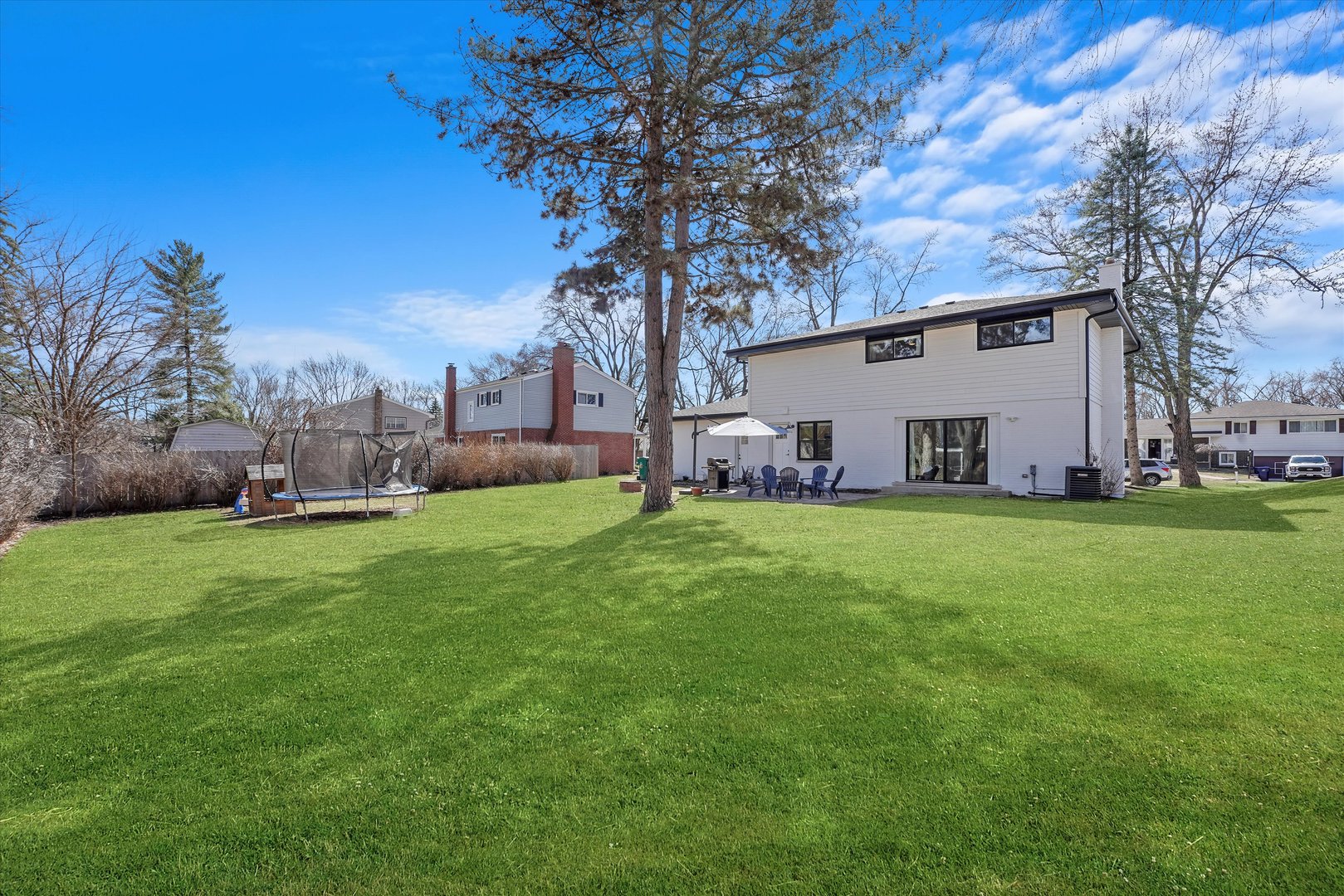 Undisclosed Address Northbrook, IL 60062 - Photo 4 of 46 a view of a house with backyard and a tree