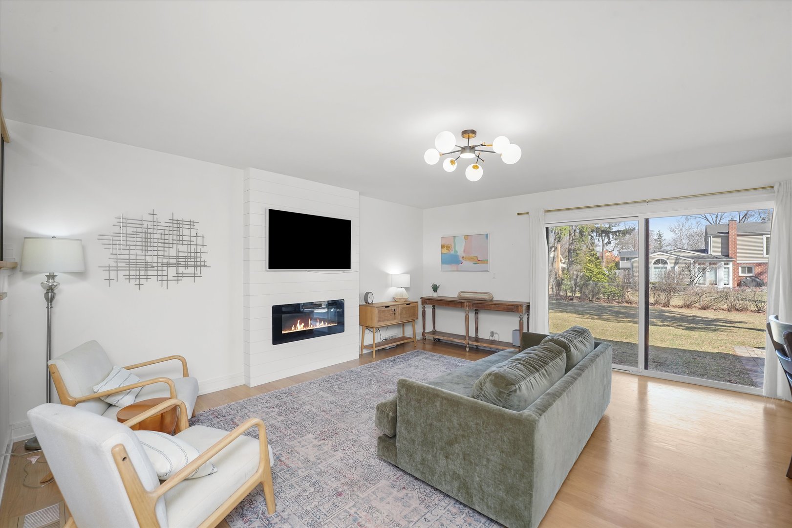 Undisclosed Address Northbrook, IL 60062 - Photo 9 of 46 a living room with furniture a flat screen tv and a floor to ceiling window