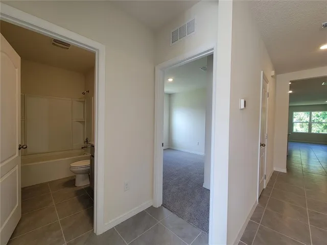 a bathroom with a granite countertop toilet and a shower