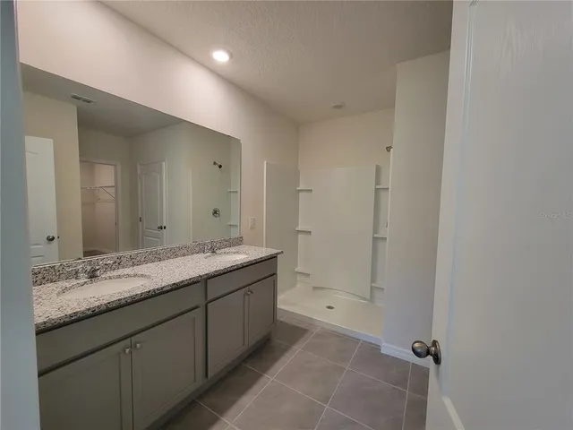 a bathroom with a granite countertop sink mirror and