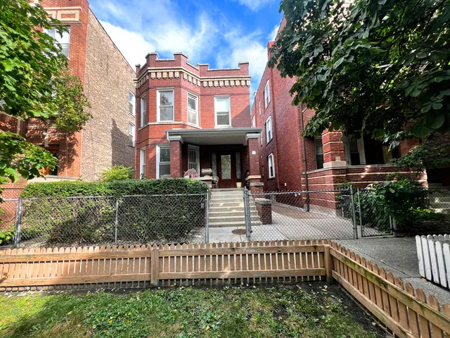 a view of a house with wooden fence