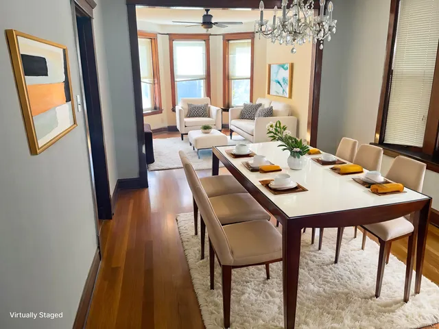 a dining room with furniture a rug and a chandelier