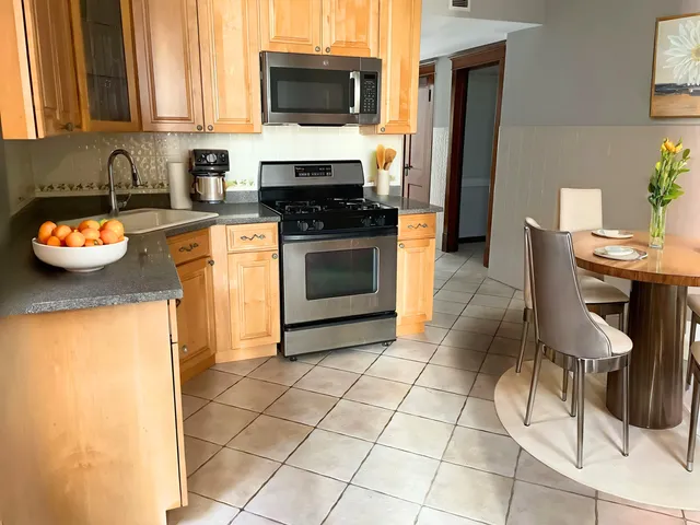 a kitchen with stainless steel appliances a stove a sink and a microwave