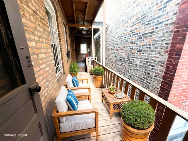 a view of balcony with wooden floor and outdoor seating
