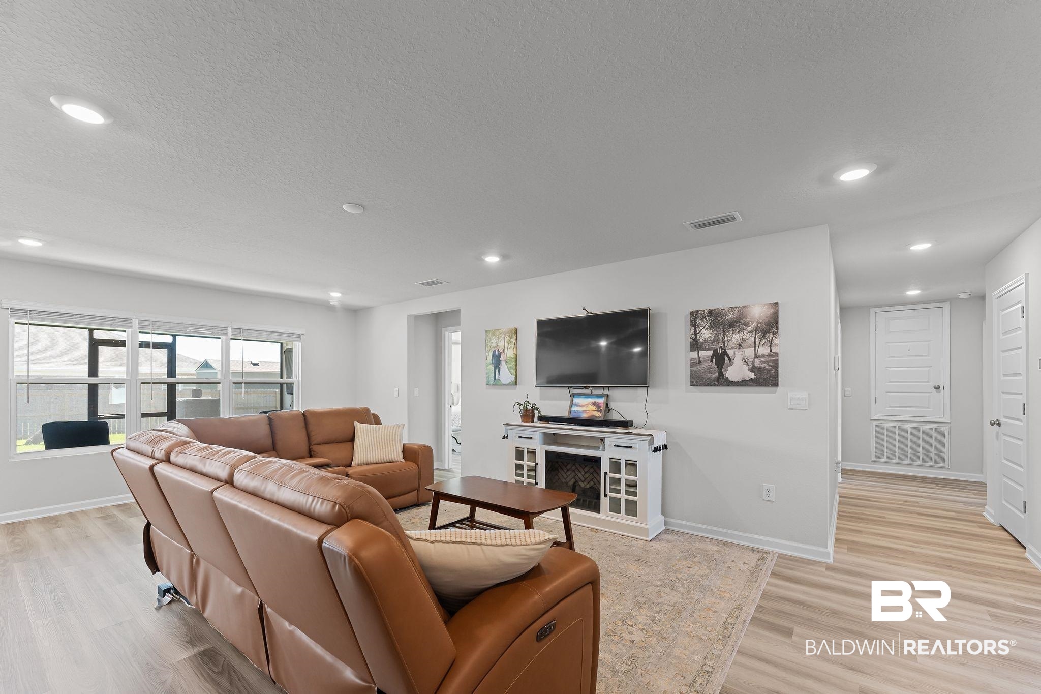 24337 Ringneck Loop Elberta, AL 36530 - Photo 7 of 34 Living room featuring light wood-type flooring, recessed lighting, and a textured ceiling